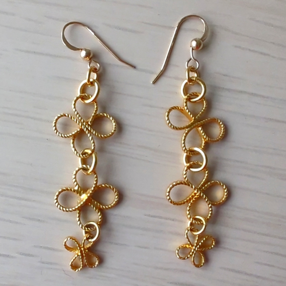 Gold colored fleur flower dangling earrings